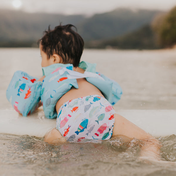 Kaleimamo Hawaii Kahua ʻĀina cloth diaper kū i ke koʻa baby on surfboard